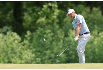 Matt FItzpatrick chips cross-handed.